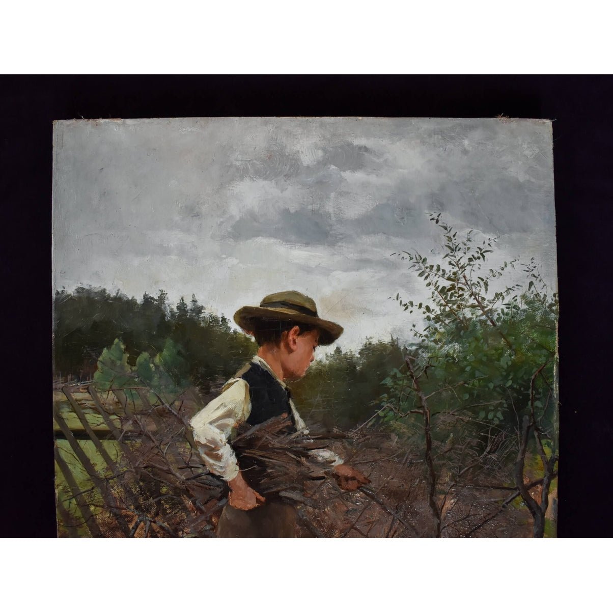 Oil painting by Elisabeth Warling titled 'Boy Gathering Wood' (c. 1890), depicting a barefoot boy collecting branches in a rustic Swedish landscape, naturalistic style, earthy tones, signed lower left.