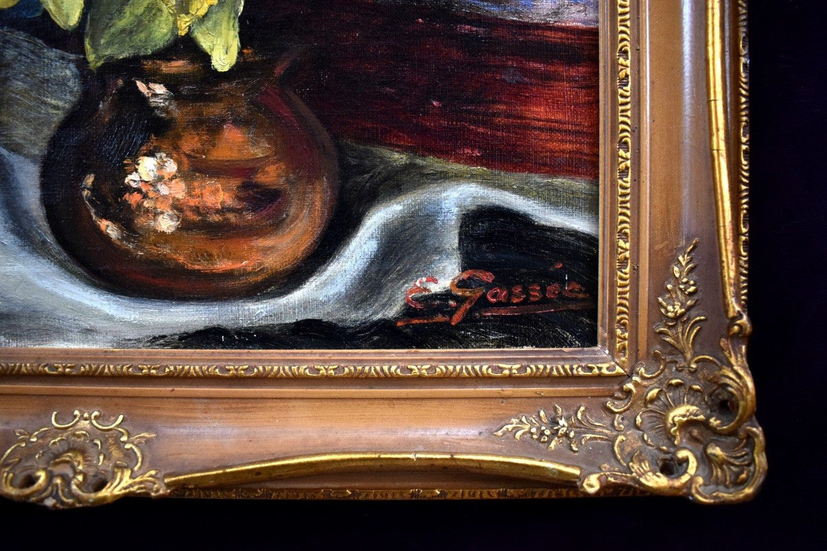 E. Gassée 1950s Belgian oil painting still life with red devil mask, blue irises, yellow daffodils in ornate gold baroque frame