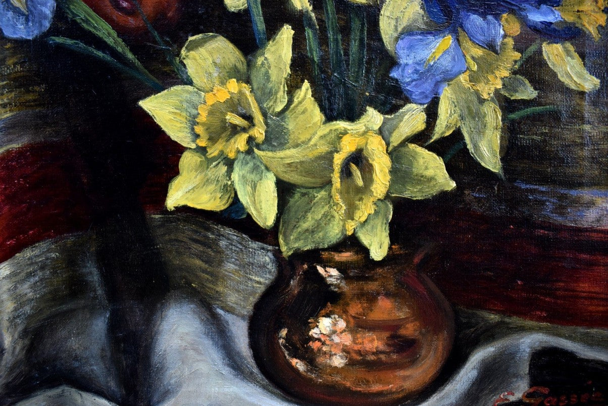 E. Gassée 1950s Belgian oil painting still life with red devil mask, blue irises, yellow daffodils in ornate gold baroque frame
